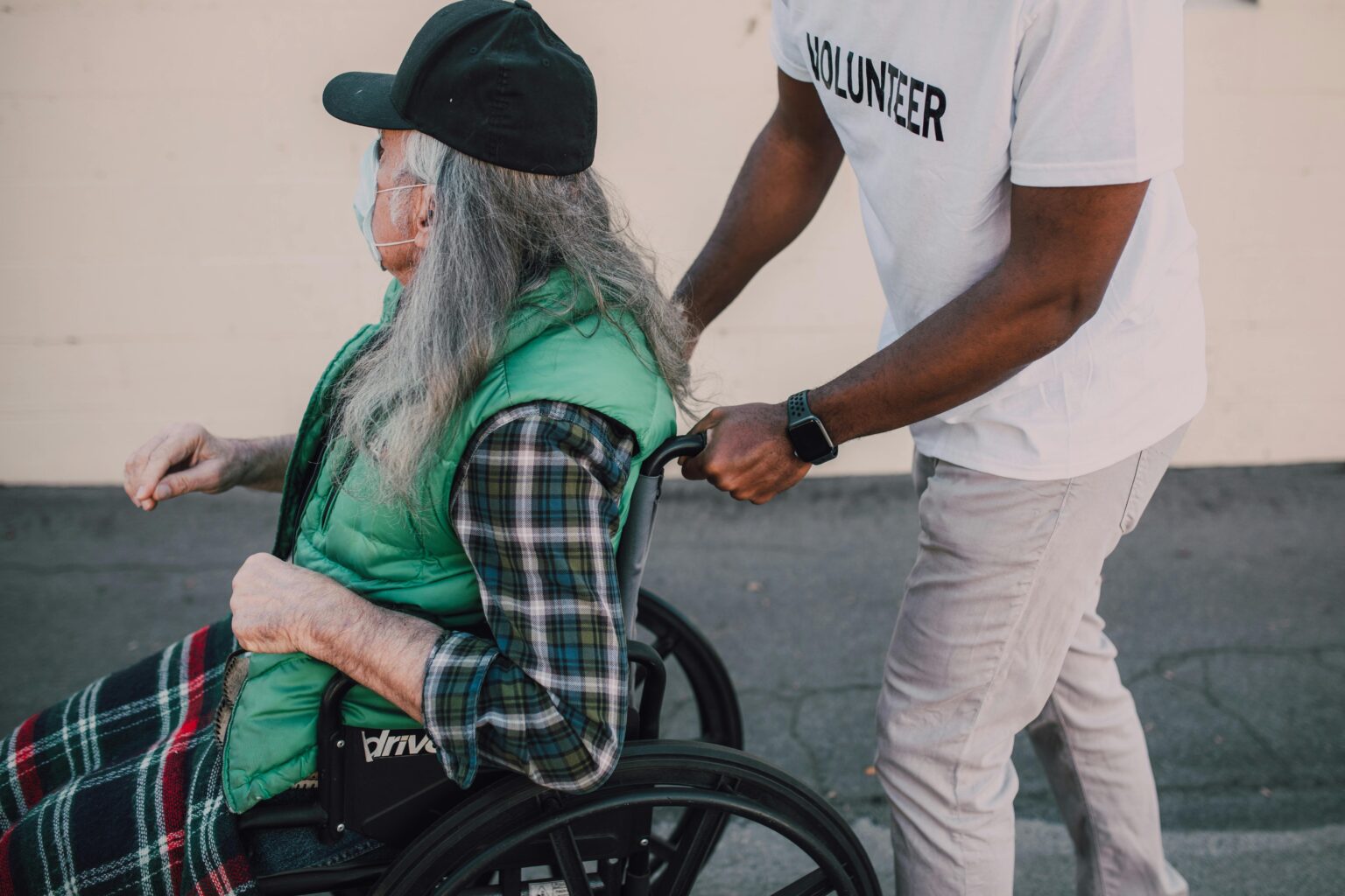 A man in a wheelchair with an older woman.